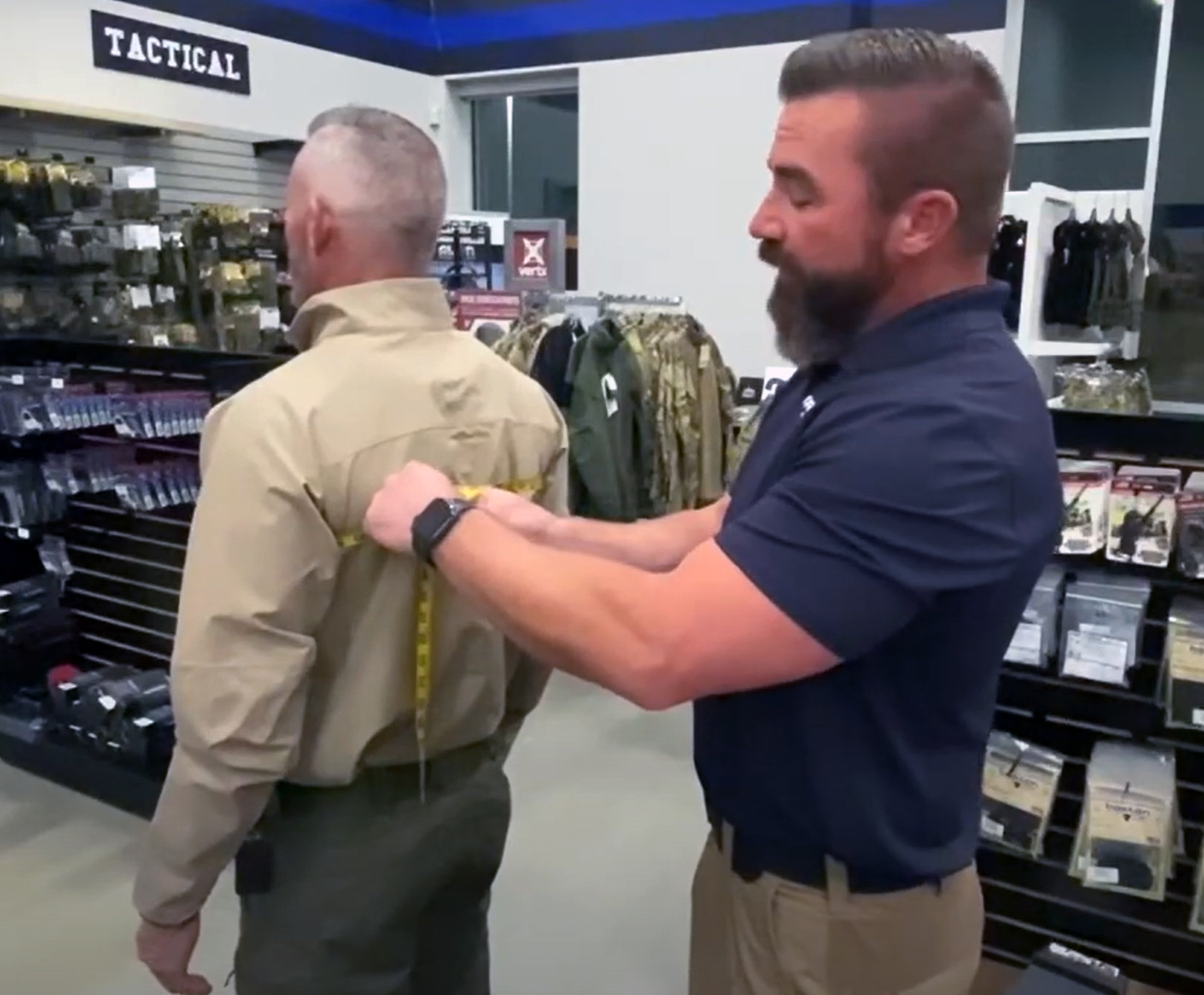 A Curtis Blue Line employee measures a law enforcement officer for an armor carrier.